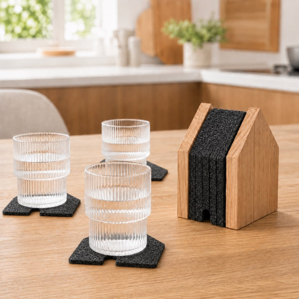 Oak coaster holder with felt coasters on table