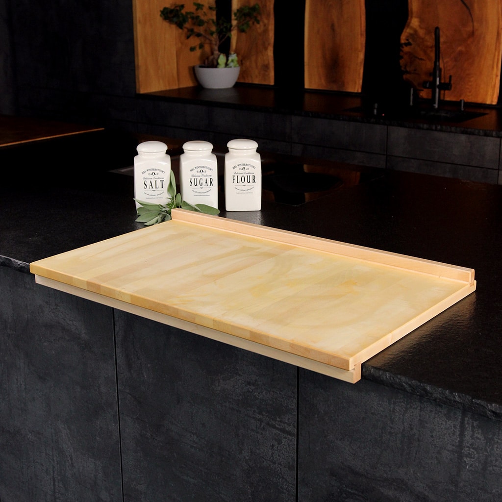 Solid maple pastry board with raised edges on a kitchen counter